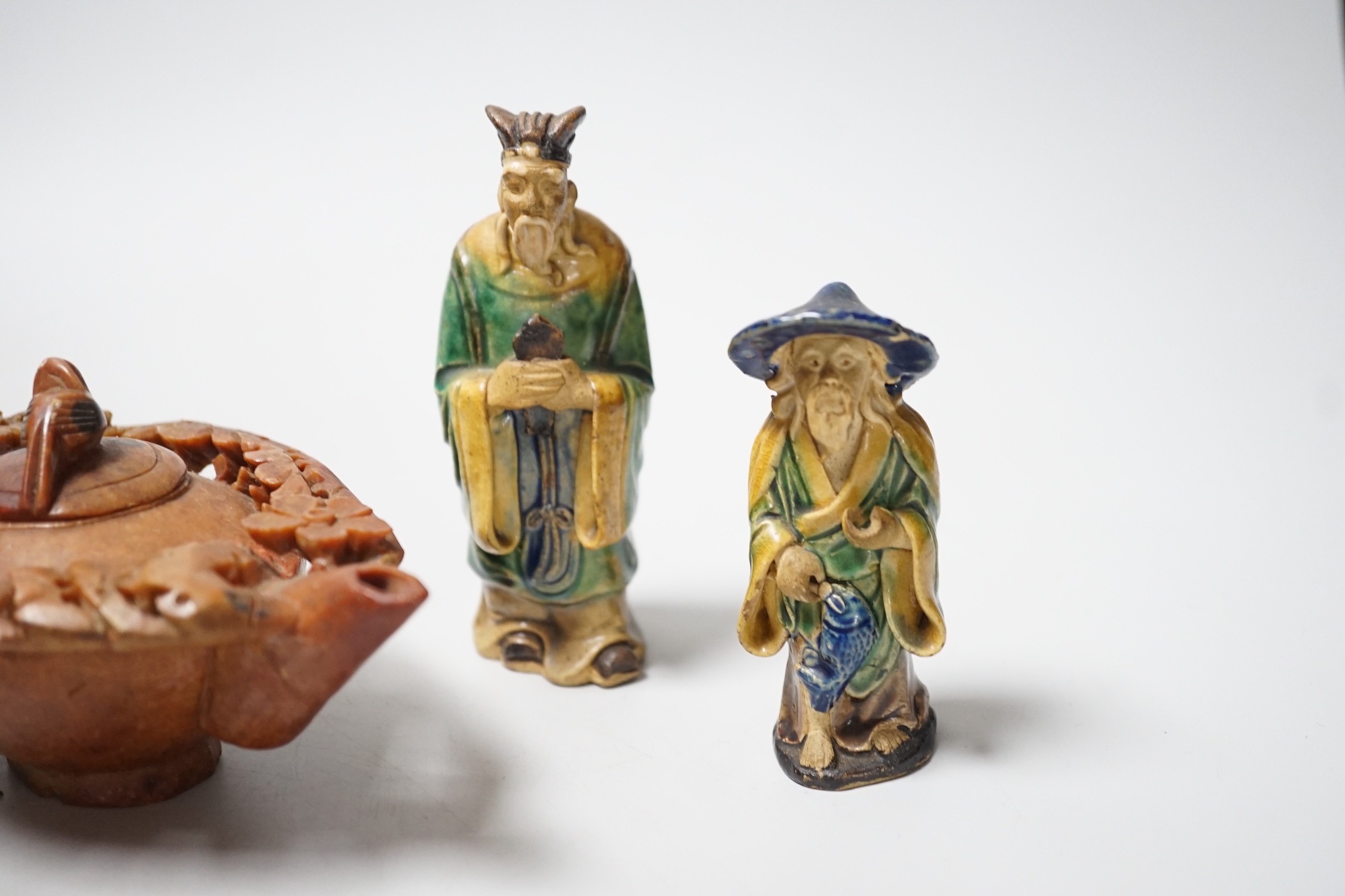 A Chinese carved soapstone pot, a terracotta teapot, and two earthenware figures, tallest figure 11cms high